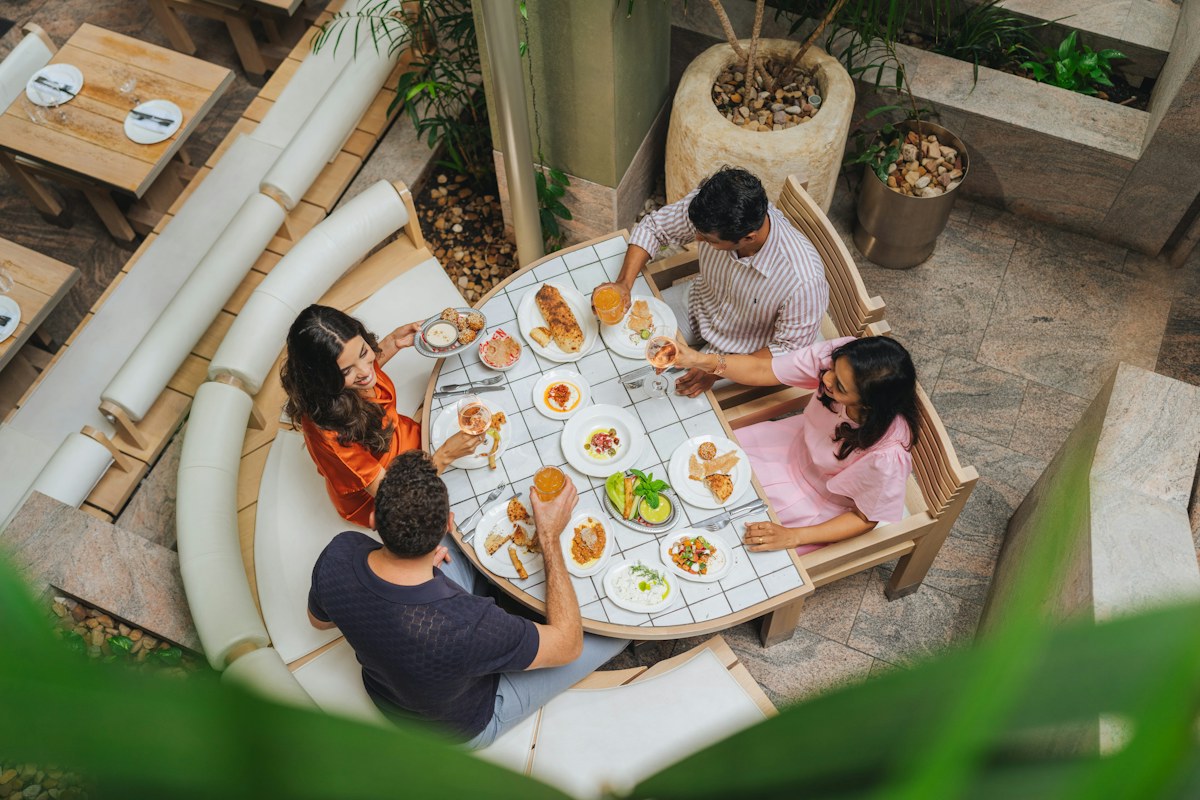 Friends sharing a meal at an outdoor restaurant